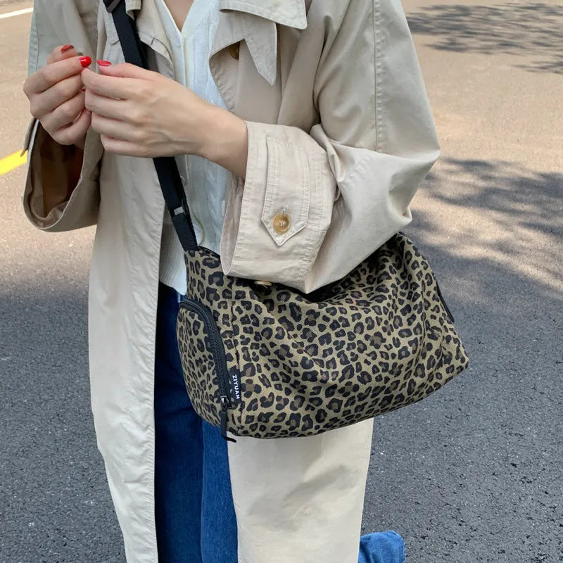 Leopard print sports style shoulder messenger bag with cross-body strap and stitching details