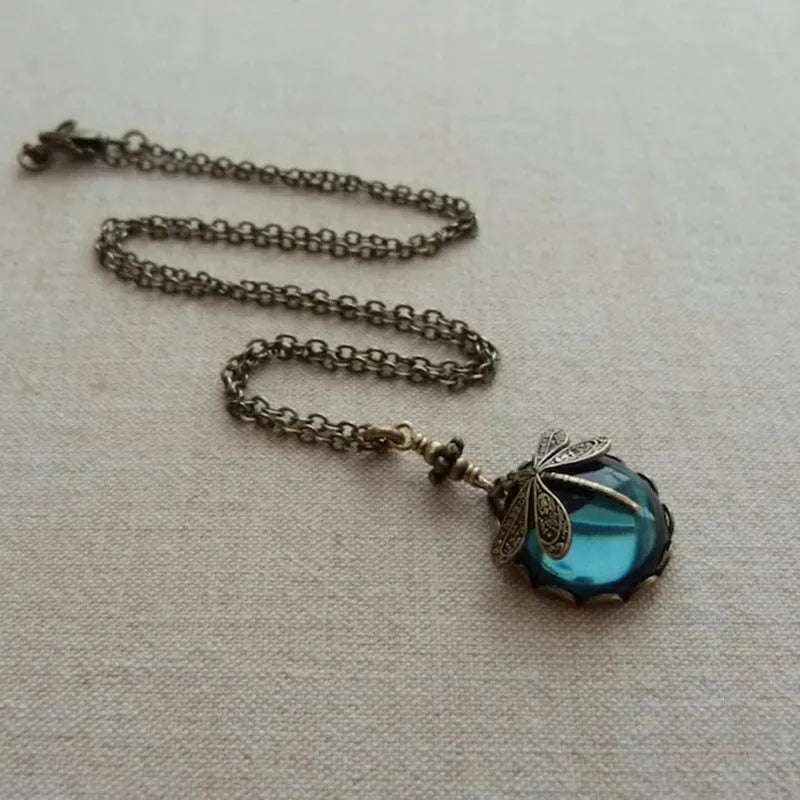 Yellow vintage bronze dragonfly pendant necklace on a silver chain, hand-carved design.