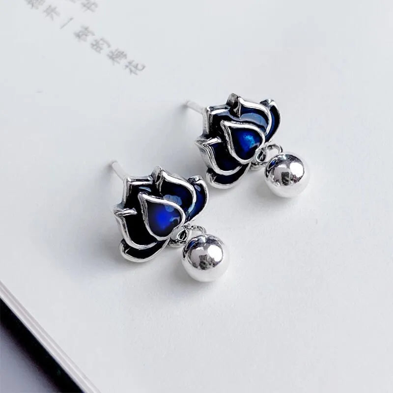 A pair of blue alloy lotus ear studs with a retro artistic seedpod and tassel design.