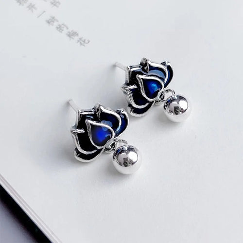 A pair of blue alloy lotus ear studs with a retro artistic seedpod and tassel design.