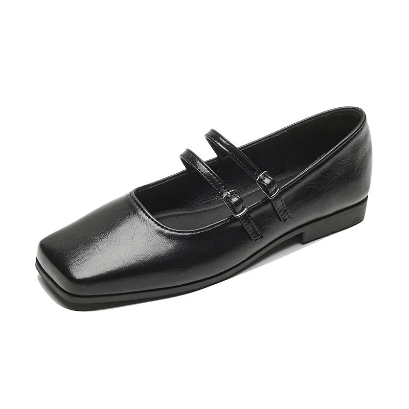 Silver women's Mary Jane ballet flats with cross buckle strap and round toe on flat low heel.