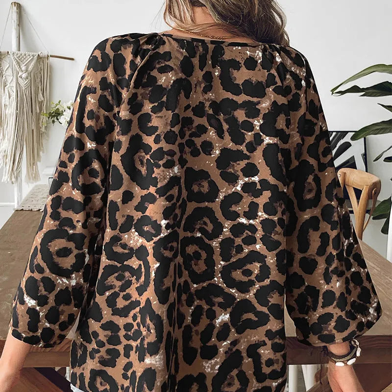 Women's leopard print polyester pullover top with V-neck and half sleeves showing pleating detail