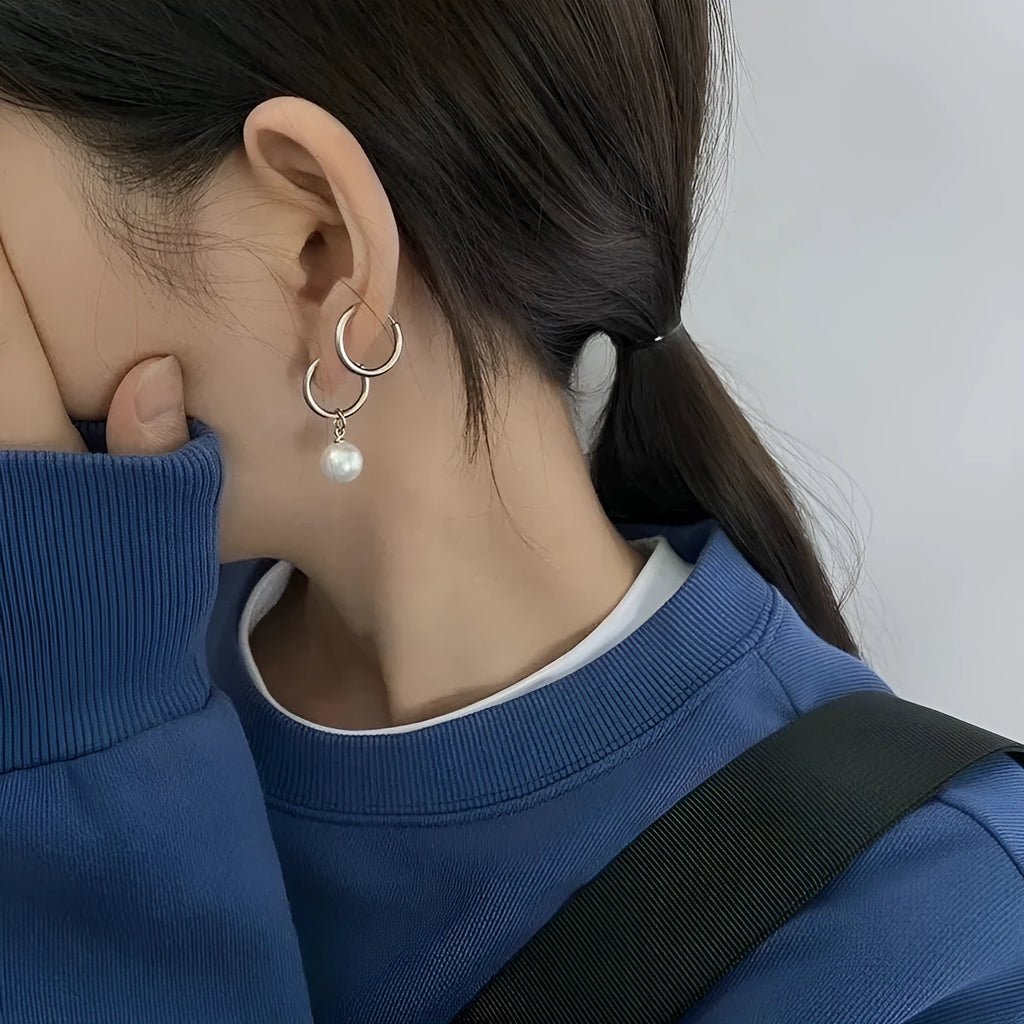 A pair of women's geometric alloy earrings with a round pearl and titanium steel posts.