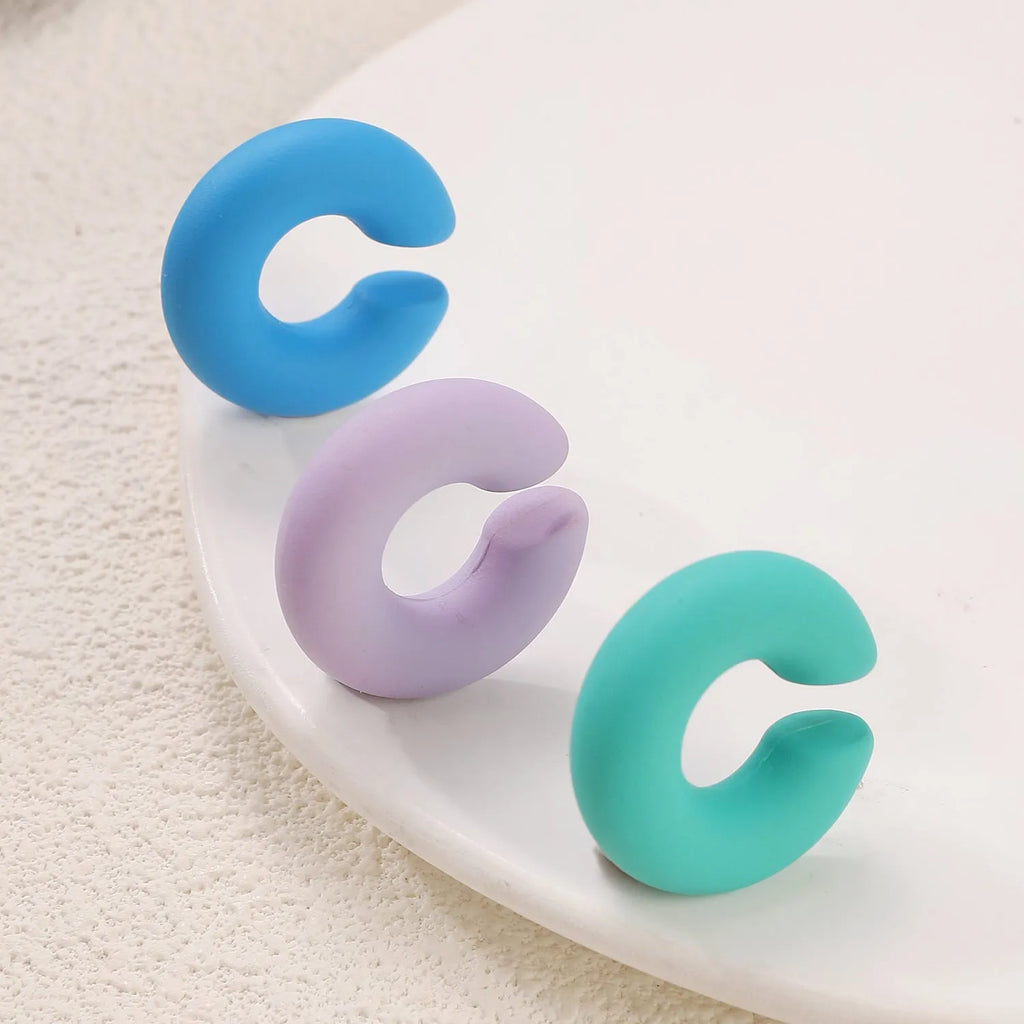 Matte coarse finish geometric C-shaped clip-on earrings for women in a selection of candy colours.