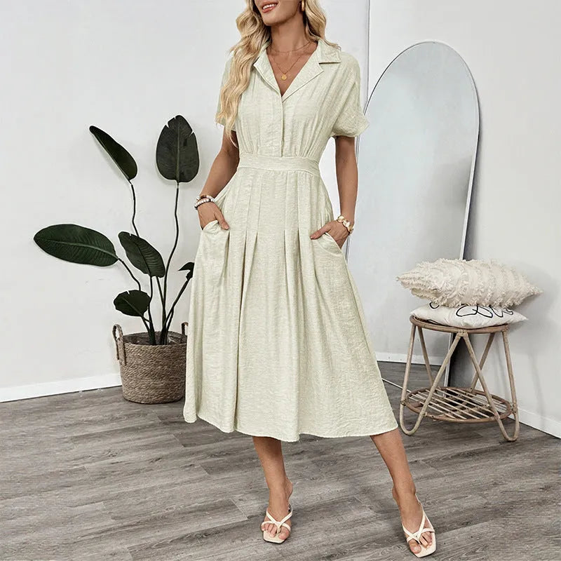 Light green knee-length shirt dress with lapel collar, waist tie, and side pockets on mannequin