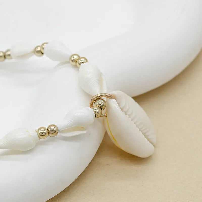 White Mother of Pearl conch shell necklace with regular chain on display