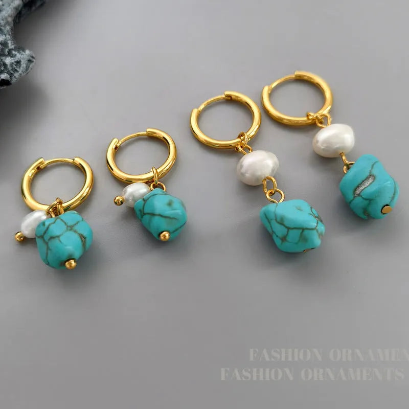A pair of irregular shaped geometric copper ear clip earrings featuring turquoise stones and cultured pearls.