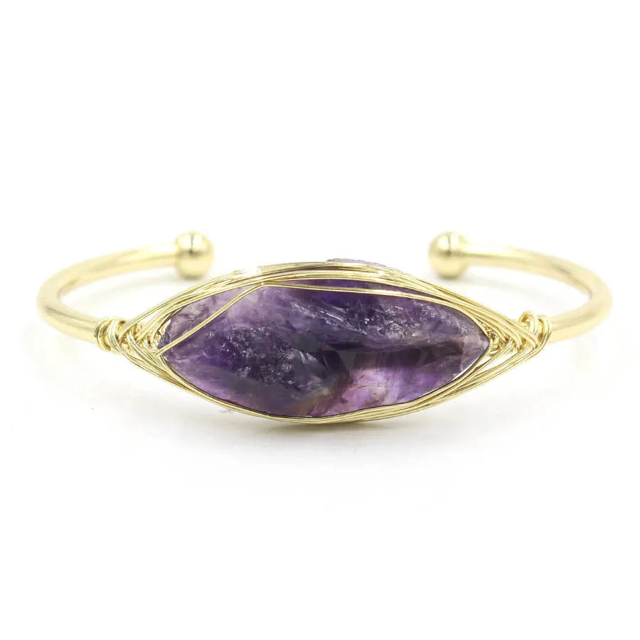 Raw gemstone winding bracelet with 8mm amorphous crystal beads in various colours on a white background.