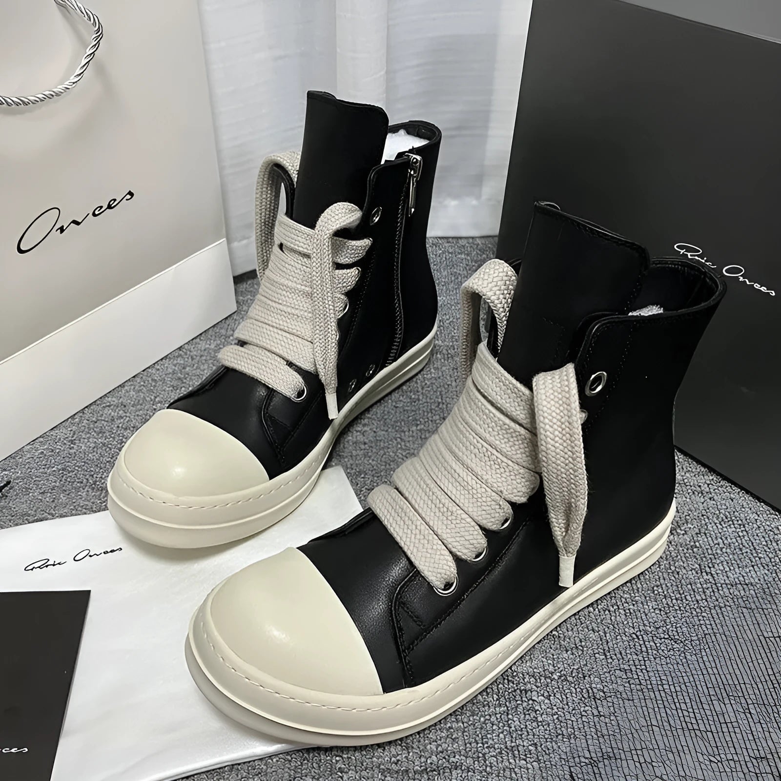 Black high-top leather boots with side zip and platform sole for men and women