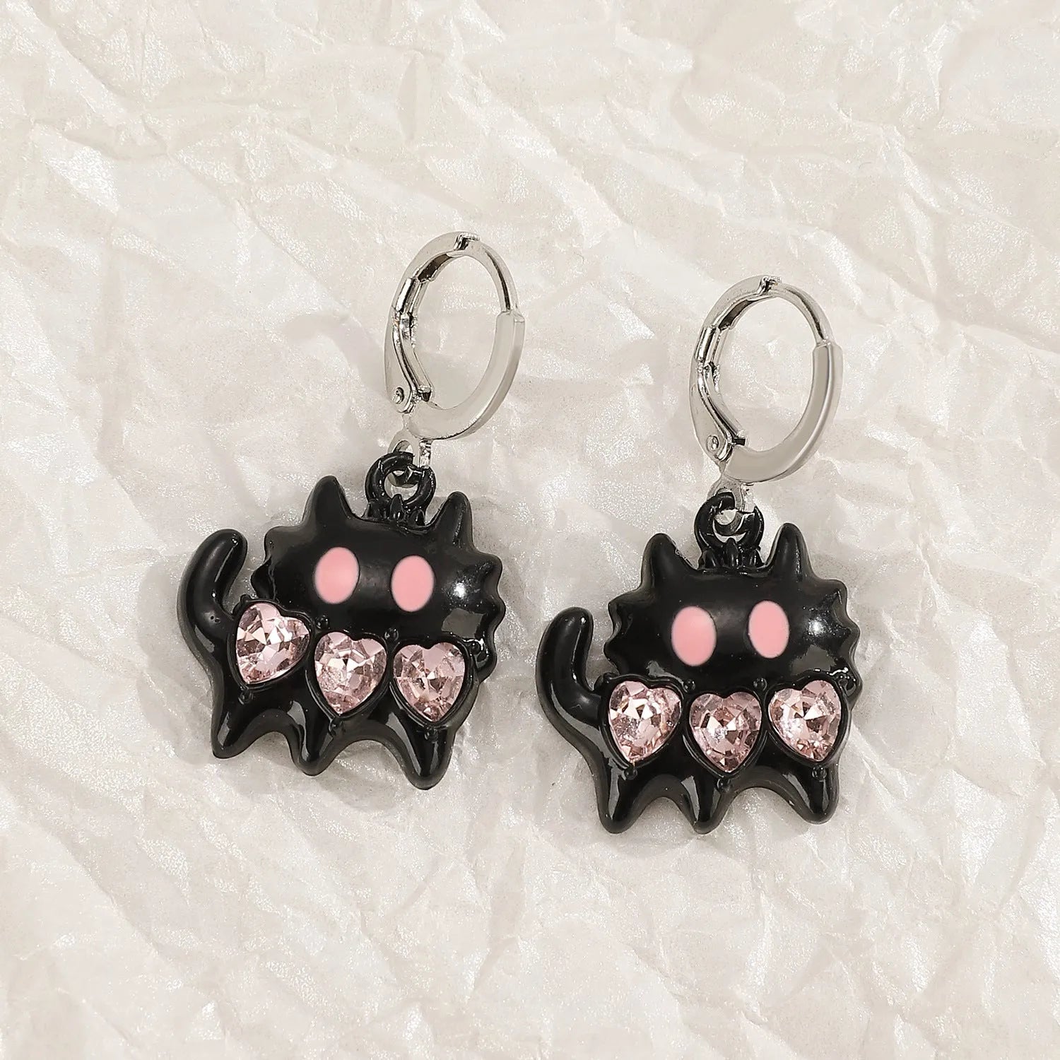 Women's alloy cross crystal earrings in white, bright black, and antique silver colours with geometric animal designs