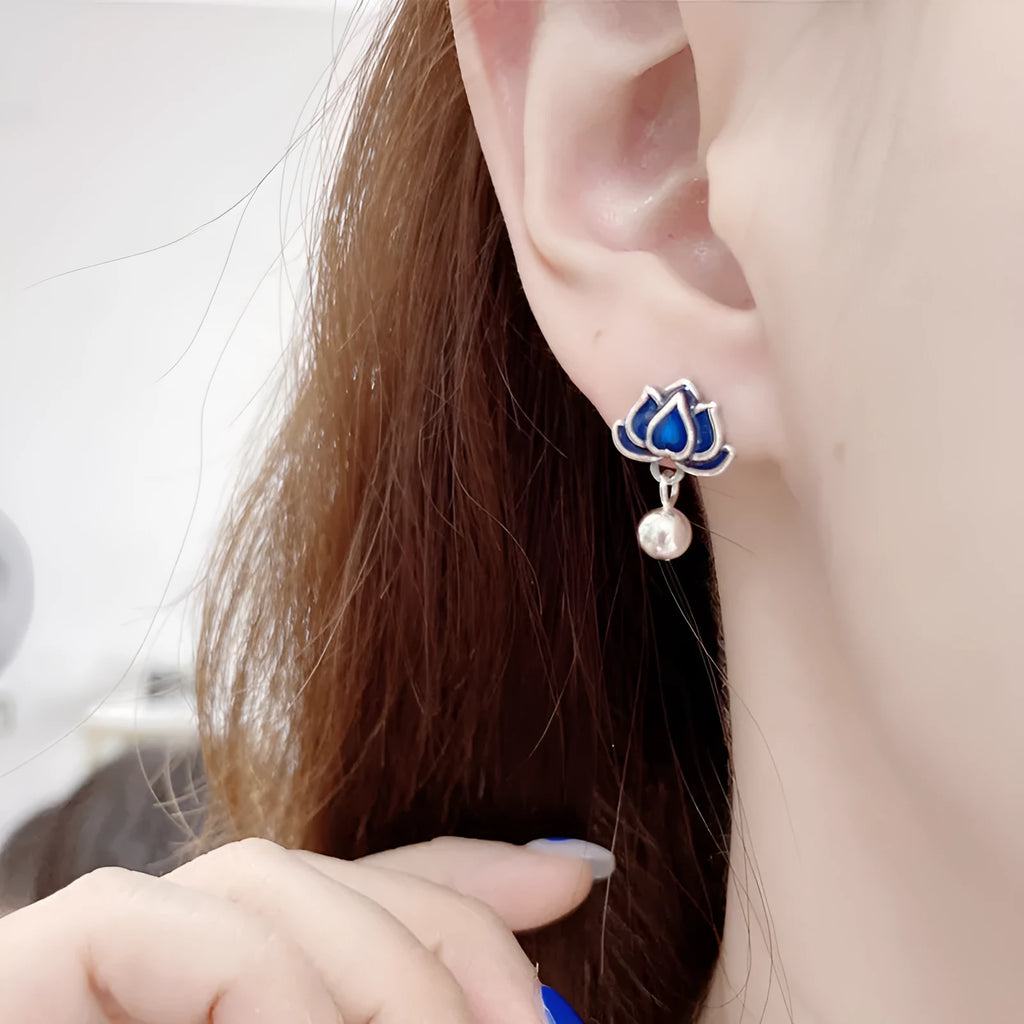 A pair of blue alloy lotus ear studs with a retro artistic seedpod and tassel design.