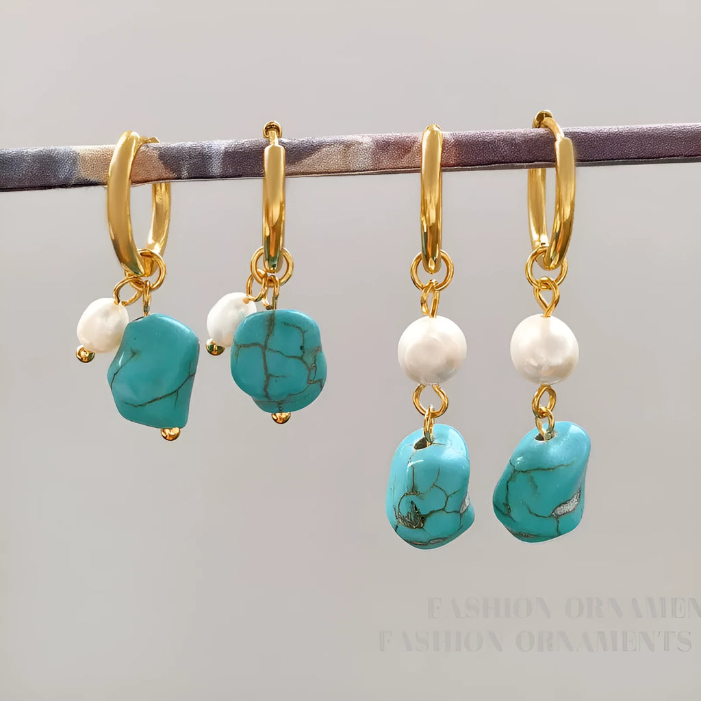 A pair of irregular shaped geometric copper ear clip earrings featuring turquoise stones and cultured pearls.
