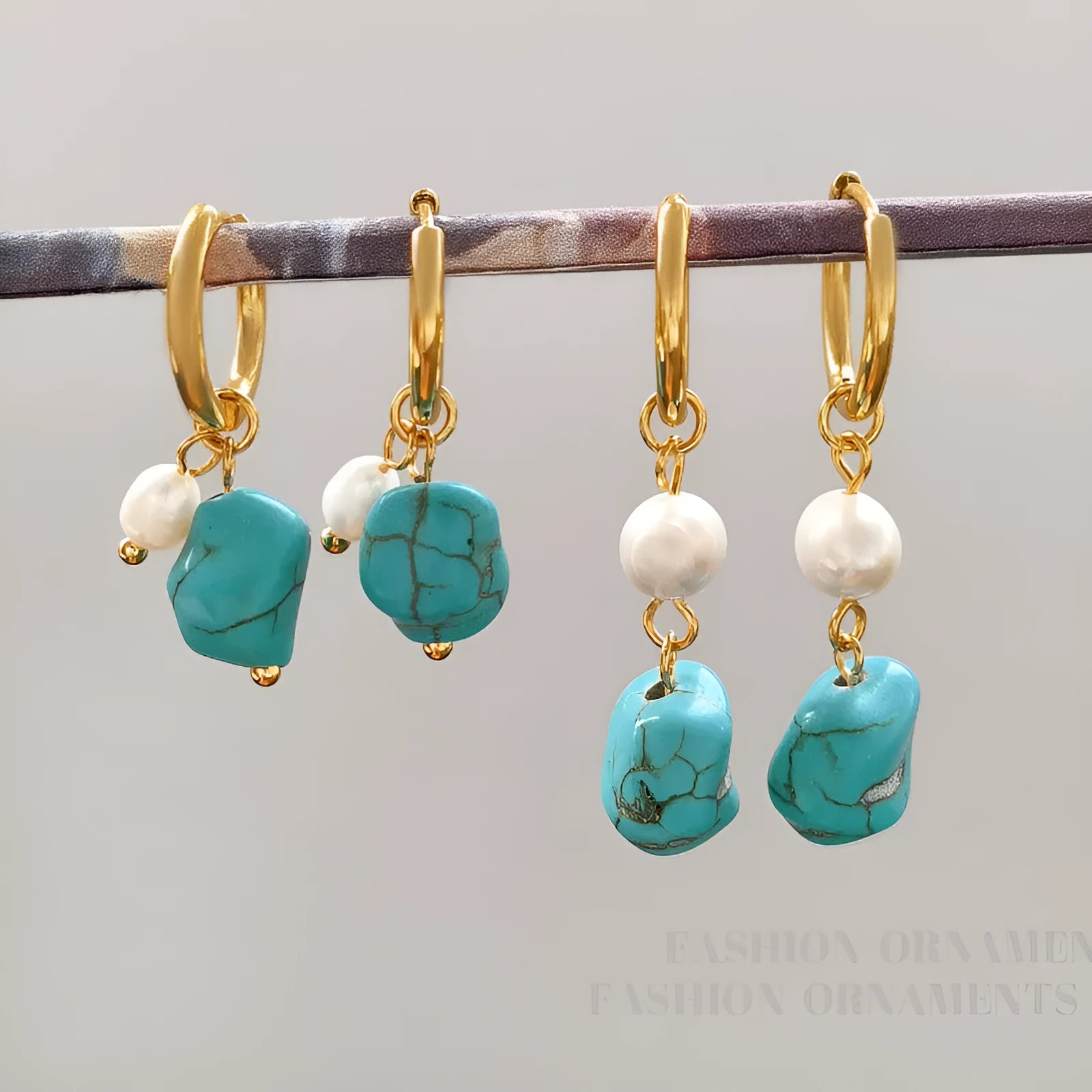 A pair of irregular shaped geometric copper ear clip earrings featuring turquoise stones and cultured pearls.
