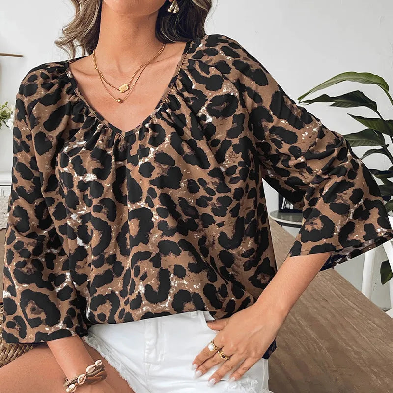 Women's leopard print polyester pullover top with V-neck and half sleeves showing pleating detail
