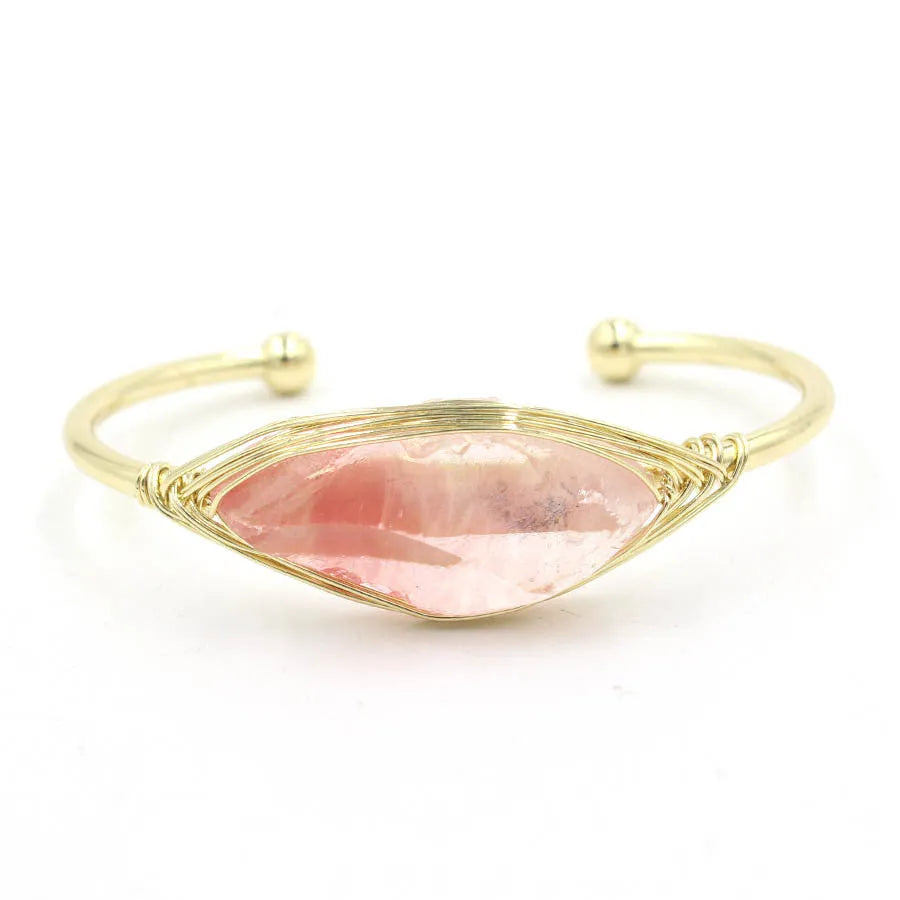 Raw gemstone winding bracelet with 8mm amorphous crystal beads in various colours on a white background.