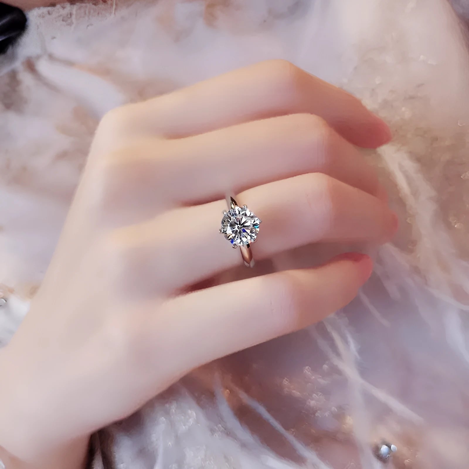 White gold plated geometric ring with a six-claw zircon setting on a hand.