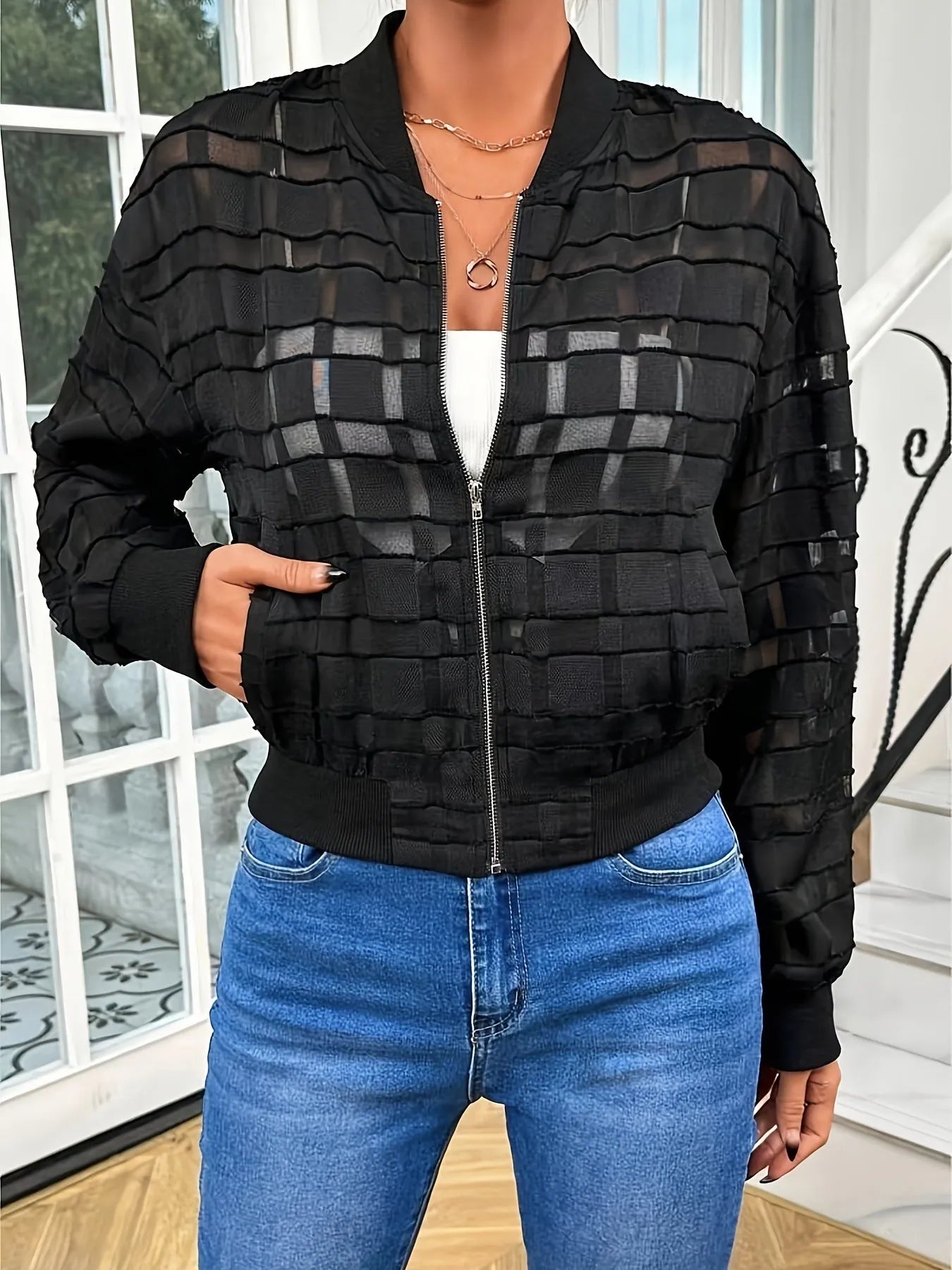 Black women's semi-transparent jacket with geometric pattern, zip-up front, and long sleeves