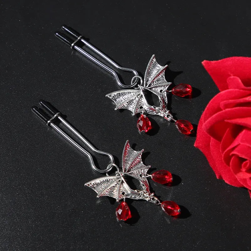 Silver alloy diamond bat nipple clamp set with ruby clip details and adjustable tension mechanism