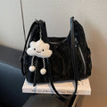 Women's soft PU fashion backpack in black, shown as a multi-functional shoulder bag with a pendant accessory.