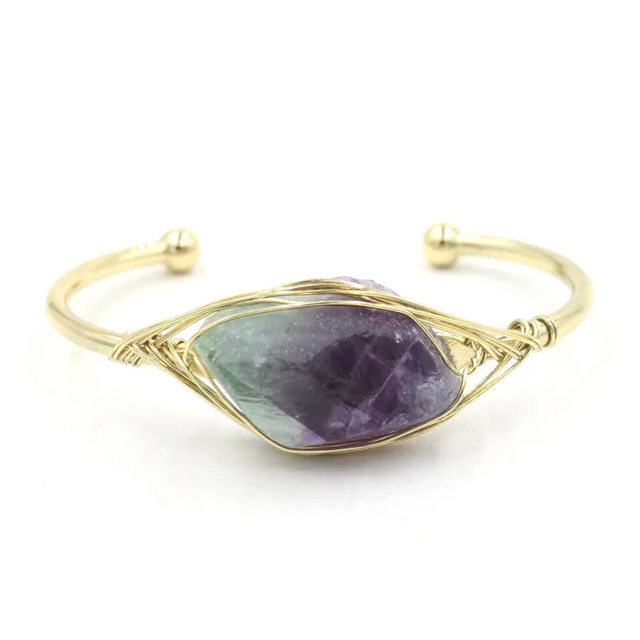 Raw gemstone winding bracelet with 8mm amorphous crystal beads in various colours on a white background.
