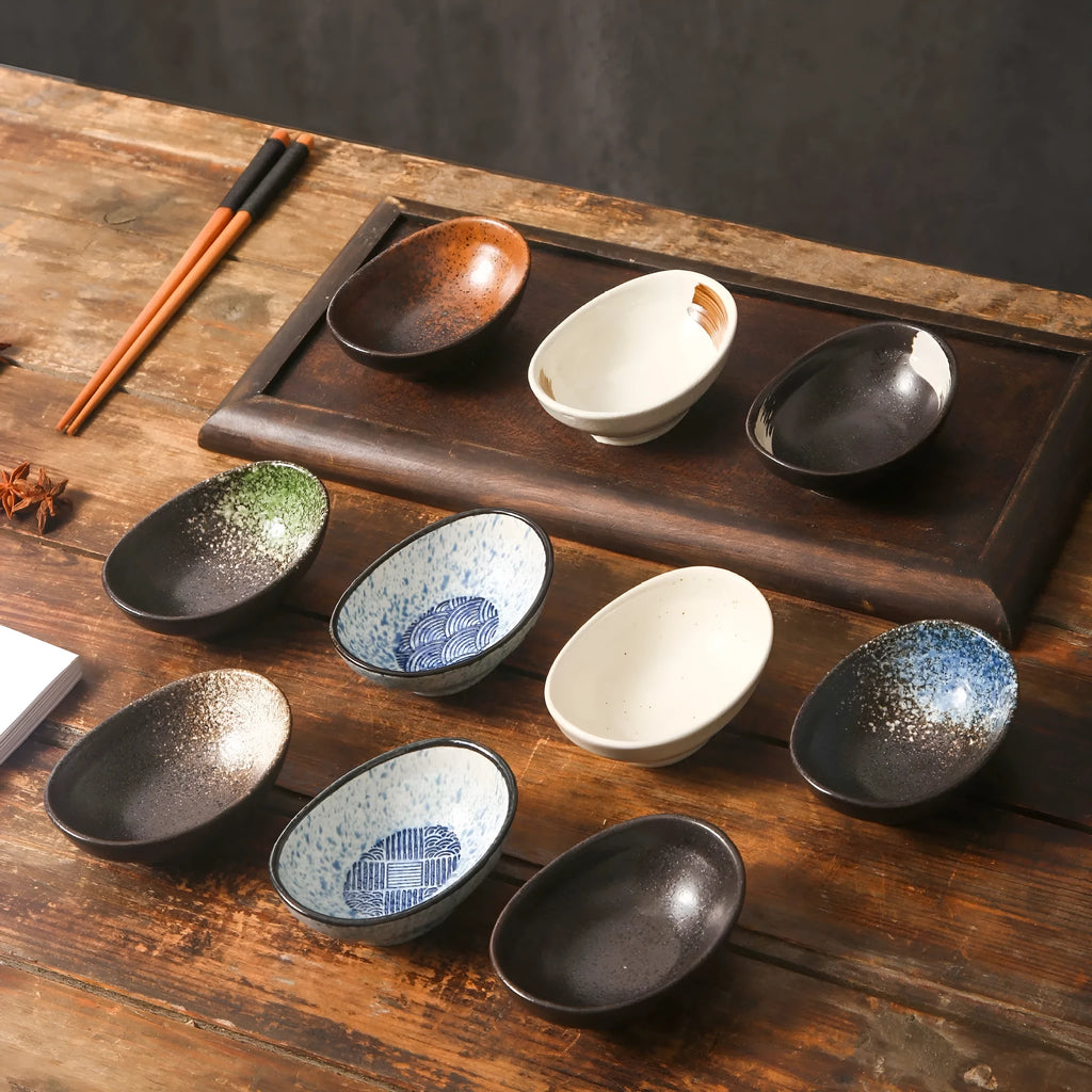 Oval Japanese ceramic sauce dipping bowl on a table, showing its 5cm height and decorative underglaze pattern.