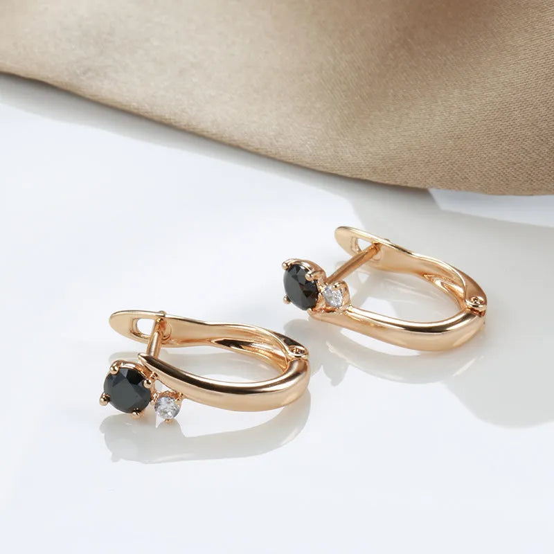 Gold geometric drop shape earrings with retro design and stone inlay on copper.