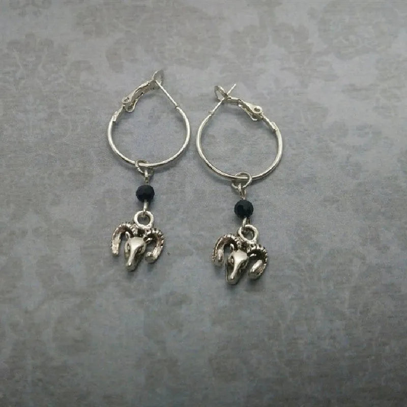 Silver-coloured alloy round hoop earrings with closed loop design on white background