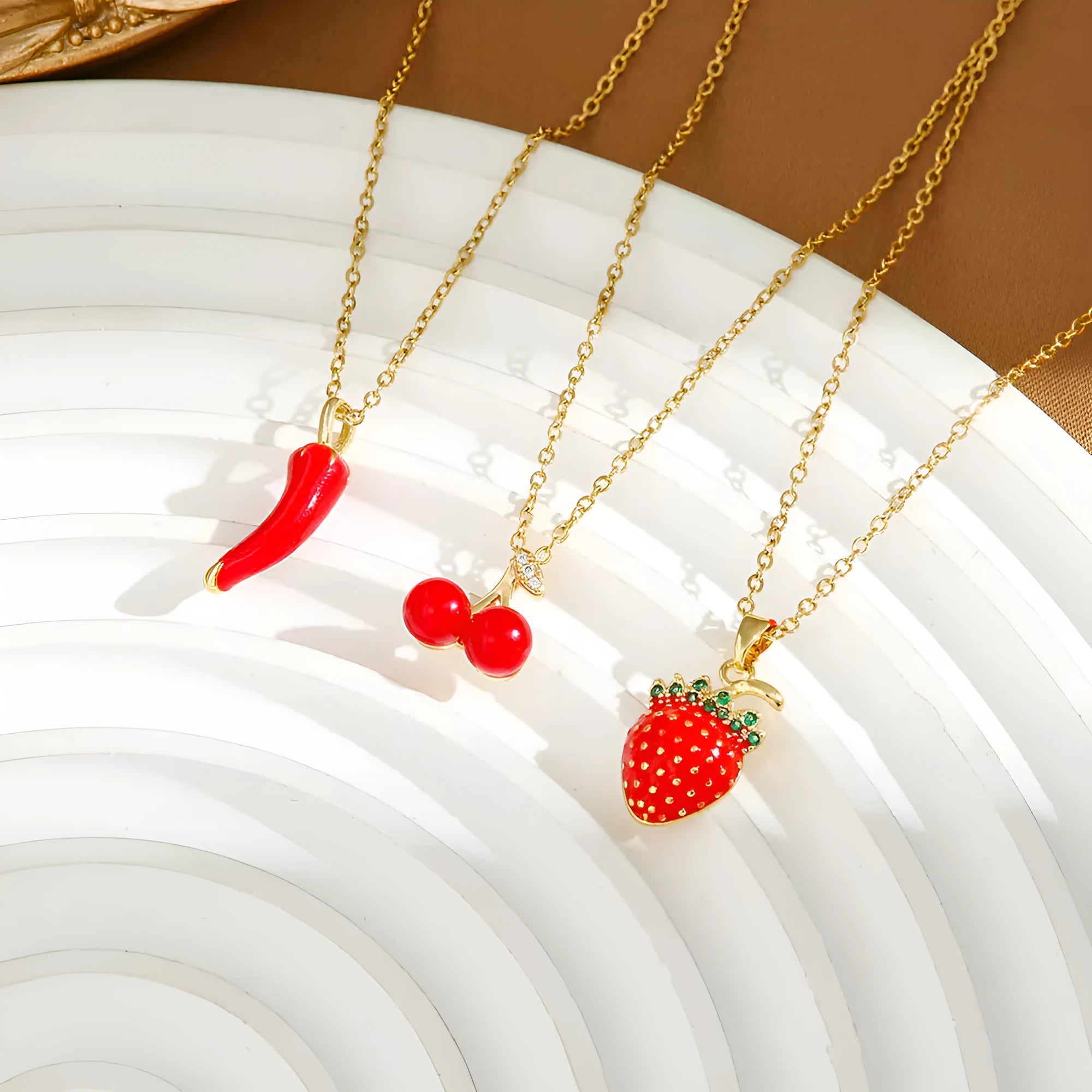 Delicate indie women's necklace with cherry, strawberry and pepper charms on a titanium steel O-ring chain.