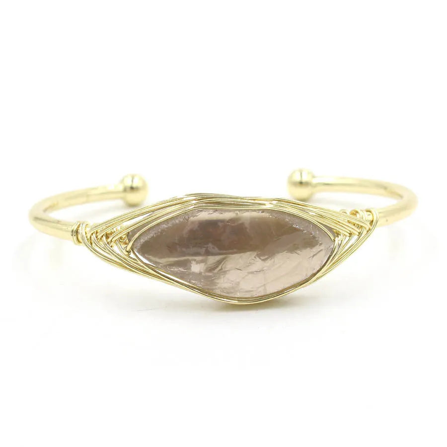 Raw gemstone winding bracelet with 8mm amorphous crystal beads in various colours on a white background.