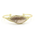 Raw gemstone winding bracelet with 8mm amorphous crystal beads in various colours on a white background.