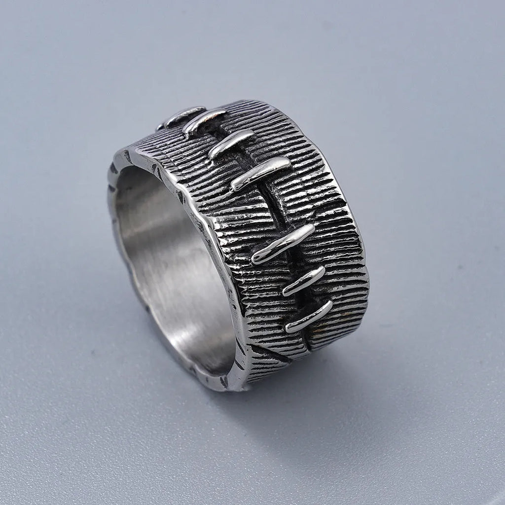 Geometric dark punk titanium steel double ring in retro colour on a black background.