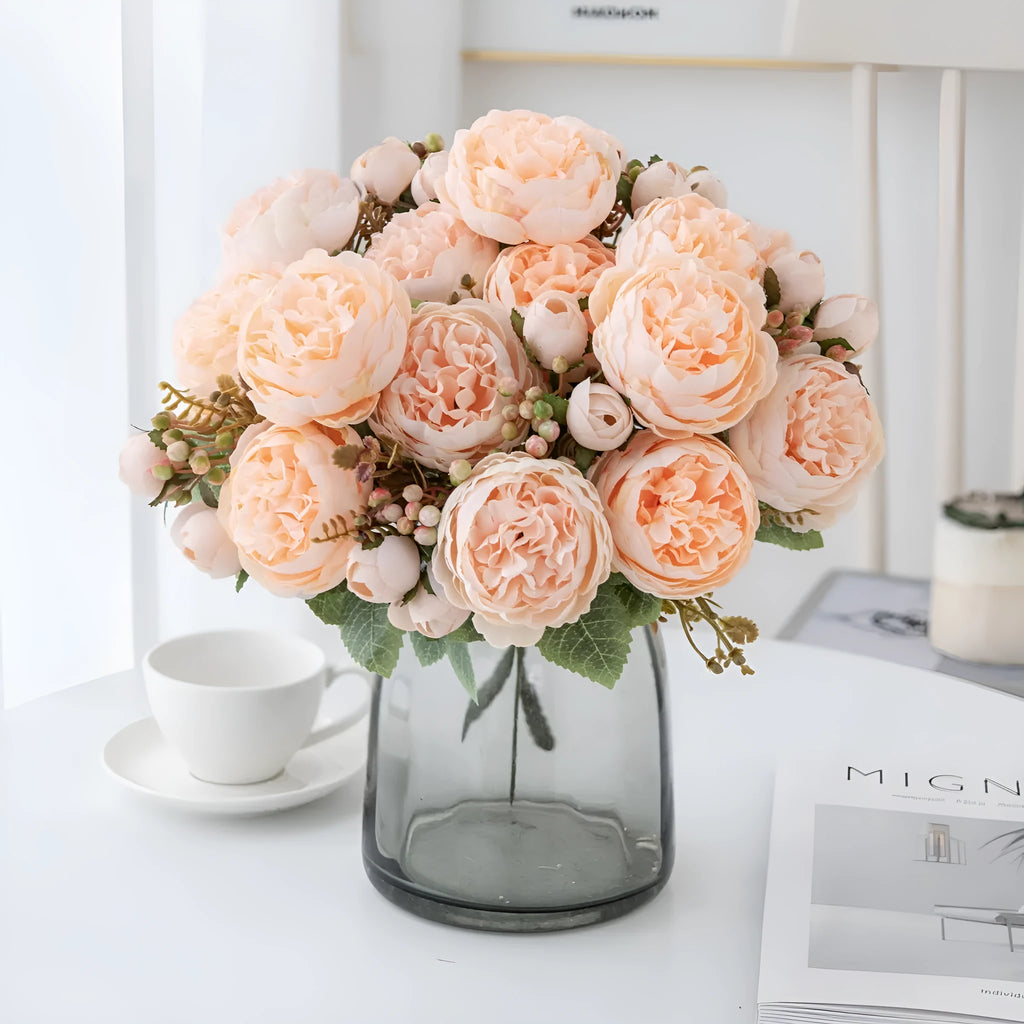 Silk artificial peony bouquet in champagne colour on a table.