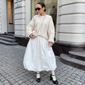 Women's long solid colour cotton skirt with elastic waist in black or white.