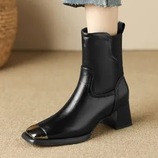 Brown women's Martin heeled leather boots with side zipper and metal rivet details.