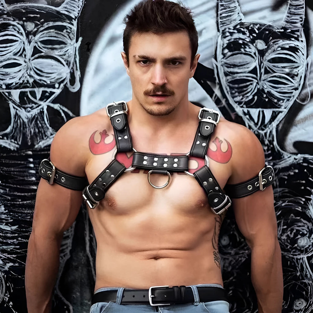 Black leather chest strap with metal buckle and rivets laid flat