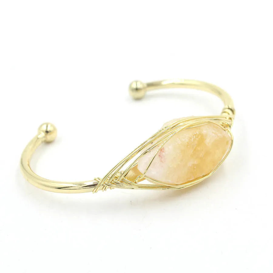 Raw gemstone winding bracelet with 8mm amorphous crystal beads in various colours on a white background.