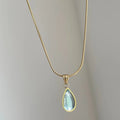 Retro water drop necklace with blue gemstone pendant on a titanium steel snake bone chain.