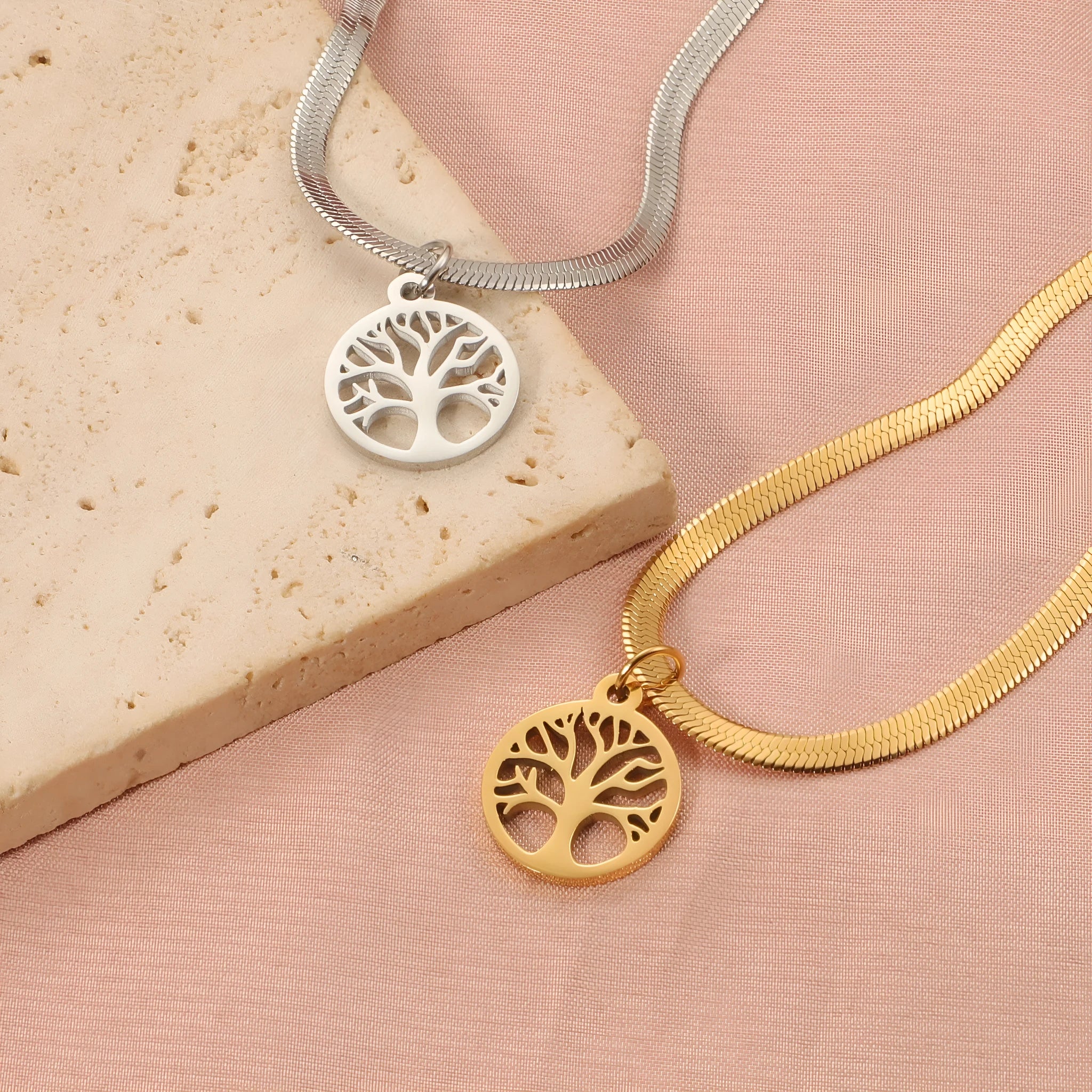 Stainless steel lucky tree pendant necklace on a snake bone chain, shown in gold and steel colour options.