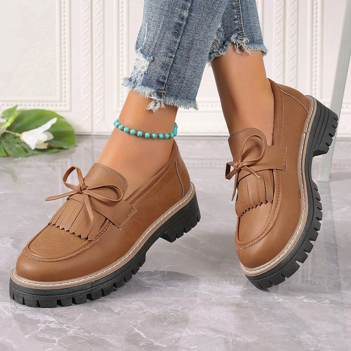 Plus size women's loafers with tassel bowknot detail in black or brown colours with chunky rubber sole