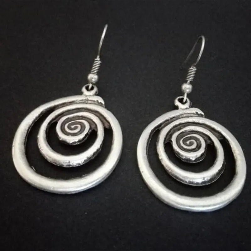Retro geometric spiral distressed silver alloy earrings showing textured finish and spiral shape
