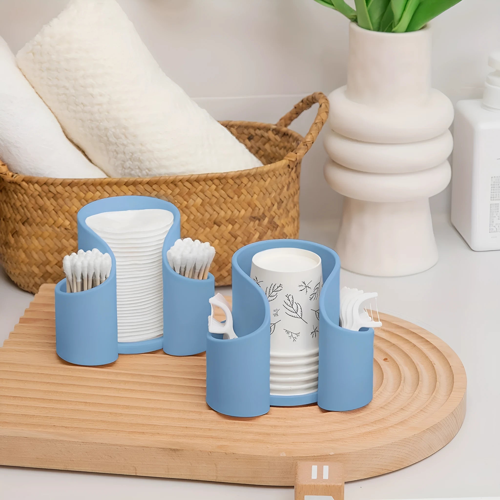 Modern solid colour plastic cotton storage box with an integrated dental floss dispenser.