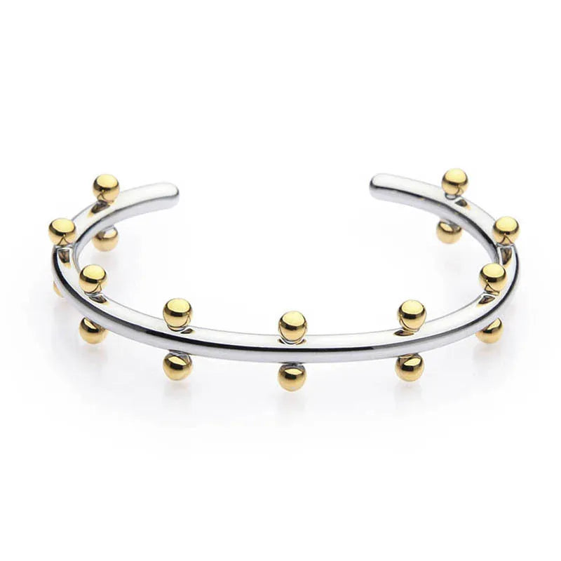 Stainless steel C-shaped bean bead with textured rivet detail in gold, silver, and two-tone finishes.