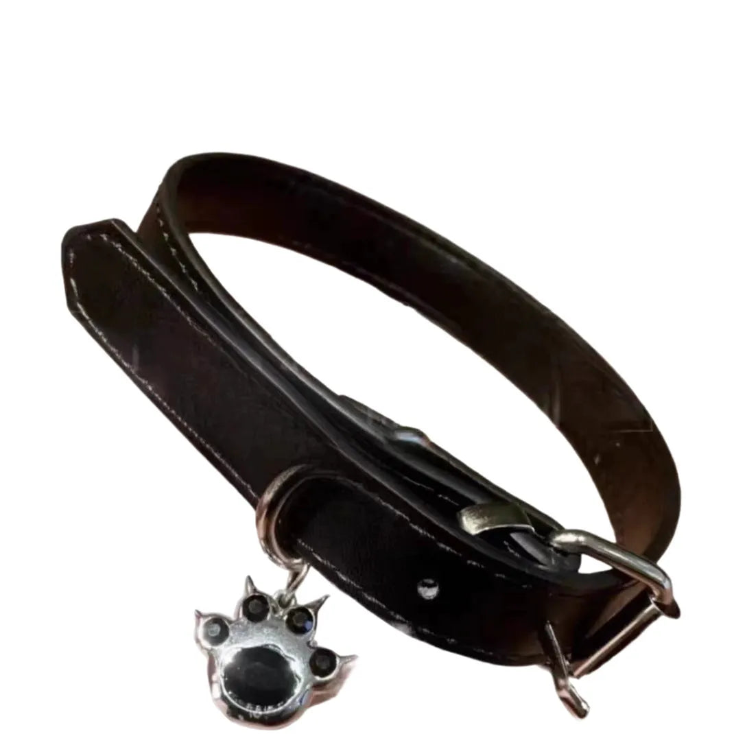 Black adjustable dog collar with bell showing three design options: LD leather, bone pattern, and cat's paw