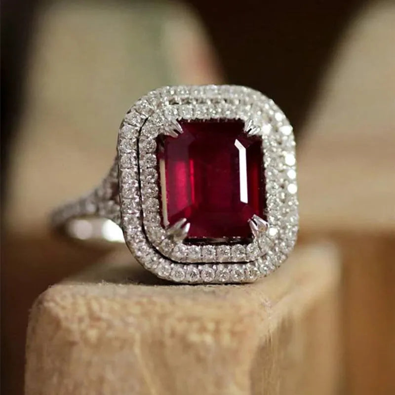 Square red copper women's ring with a central rhinestone on a white background.