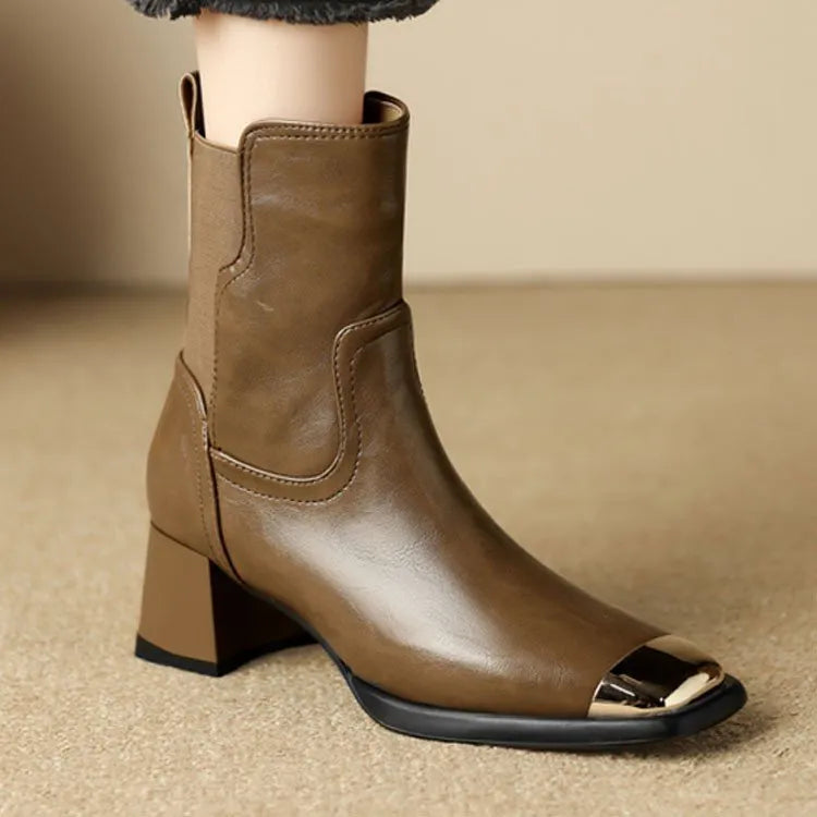 Brown women's Martin heeled leather boots with side zipper and metal rivet details.