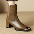 Brown women's Martin heeled leather boots with side zipper and metal rivet details.