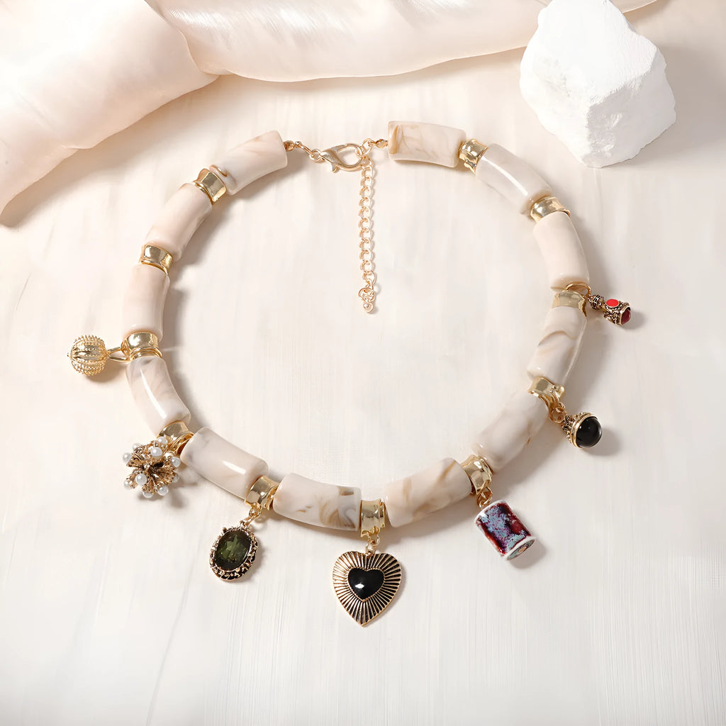 Close-up of a heart-shaped resin and bamboo pendant necklace with an electroplated finish.