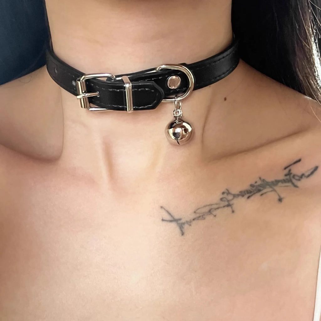 Black adjustable dog collar with bell showing three design options: LD leather, bone pattern, and cat's paw
