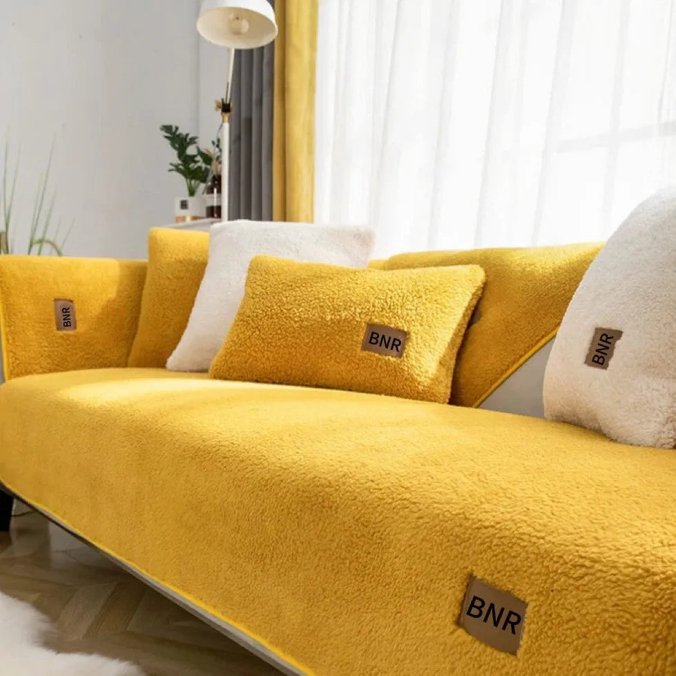 Lambswool solid colour sofa cover in blue, shown on a three-seater sofa.
