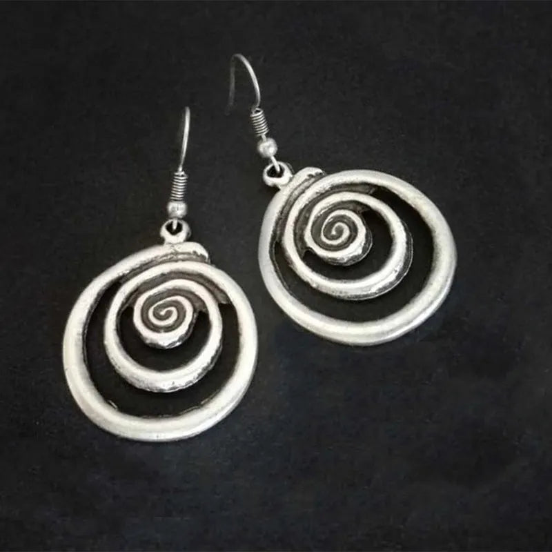 Retro geometric spiral distressed silver alloy earrings showing textured finish and spiral shape
